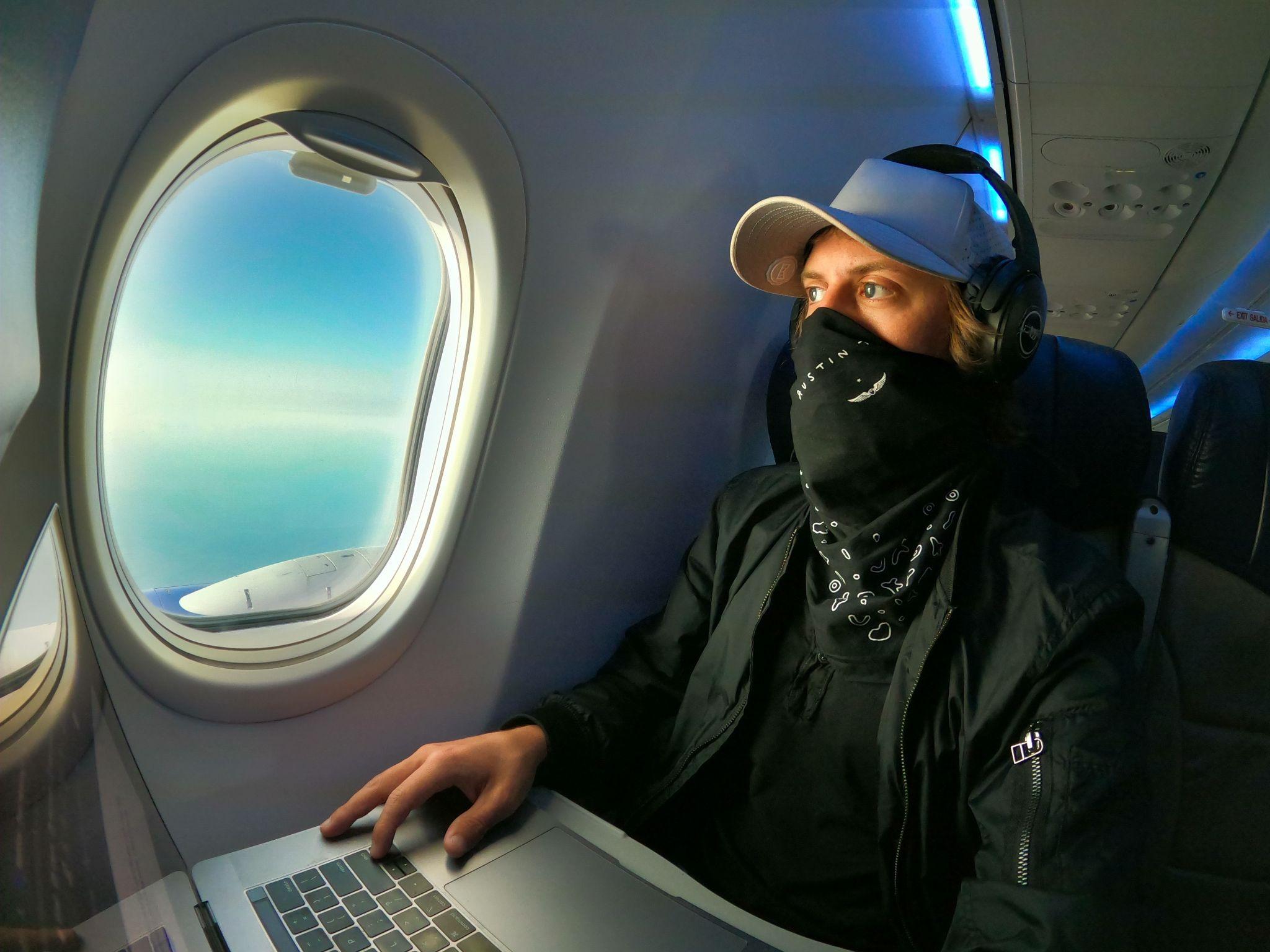 man inside a plane with laptop