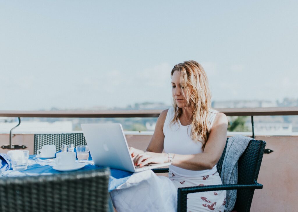 Woman with laptop on holiday