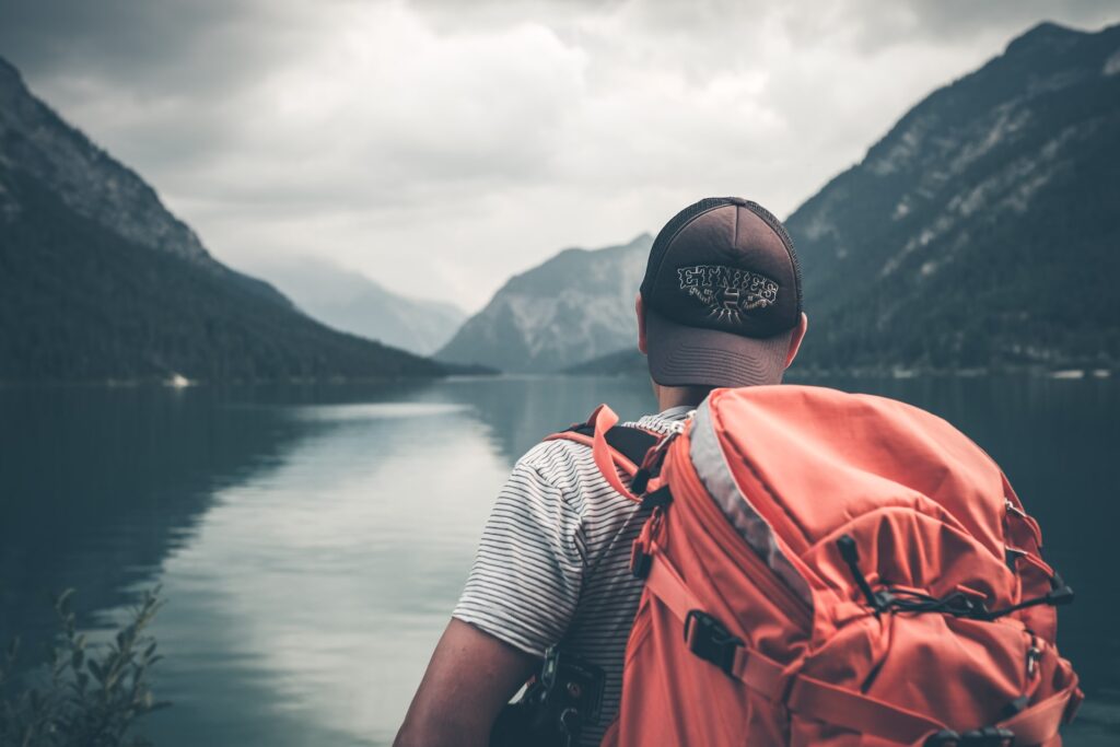 Man travelling with red backpack